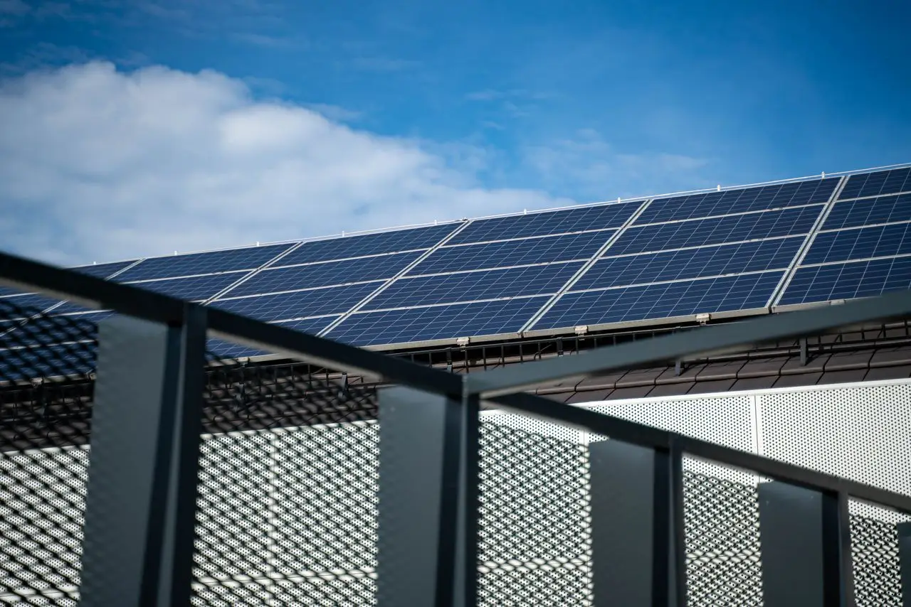 Mastering the First Impression: Your intriguing post title goes here Close-up view of modern solar panels on a rooftop against a clear blue sky, representing clean energy.
